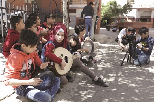 Syrian refugees from Minbej, nine-year-old Mostafa Abdallah (right) and 13-year-old Hanadi al-Hajj Abdallah (centre) seen during a scene with their friends in Beirutu2019s southern suburb of Shatila, as part of a programme called the Refugee Film Project.