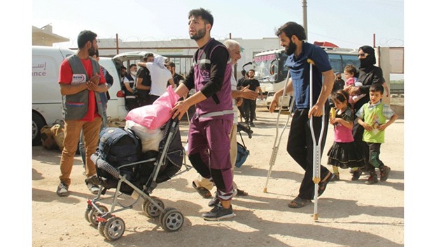 Syrian civilians and rebels, who were evacuated from the Qabun district in northeast Damascus, arrive at a temporary camp in the northern countryside of Idlib province yesterday.