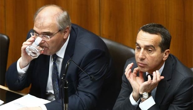 Austria's Justice Minister Wolfgang Brandstetter (left) and Chancellor Christian Kern listen during a session of the parliament in Vienna on Tuesday.