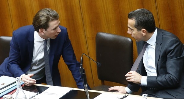 Kurz (left) and Chancellor Kern talk yesterday during a session of the parliament in Vienna.