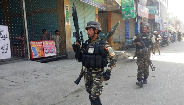 Afghan security forces arrive at the site of an attack in Jalalabad