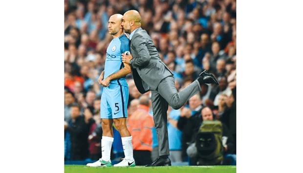 Manchester Cityu2019s Pablo Zabaleta (left) gets final instructions from manager Pep Guardiola as he comes on as a substitute for his final home appearance for the club during the Premier League match against West Bromwich Albion on Tuesday. (AFP)