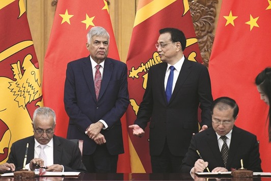 Sri Lankan Prime Minister Ranil Wickremesinghe, left, talks with Chinese Premier Li Keqiang during a signing ceremony at the Great Hall of the People in Beijing, China, recently.