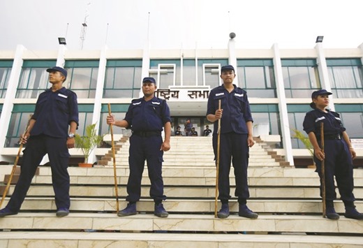 Temporary police personnel recruited for guarding the building are seen, where the votes are being counted, after the local election of municipalities and villages representatives in Kathmandu, yesterday.