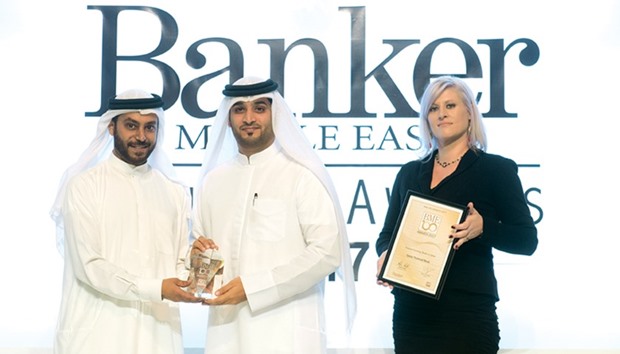 QNB official with the award.