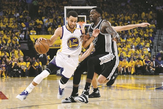 Golden State Warriors guard Stephen Curry dribbles the ball against San Antonio Spurs centre Dewayne Dedmon (right) during the first quarter in game two of the western conference finals of the NBA playoffs at Oracle Arena. PICTURE: USA TODAY Sports