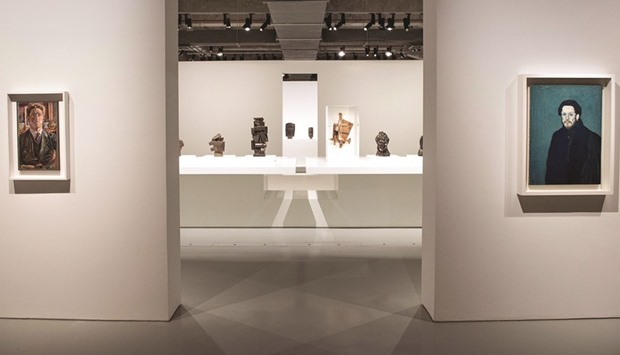 Self portraits by Alberto Giacometti and Pablo Picasso (left and right) and some sculptures are seen at the exhibition.