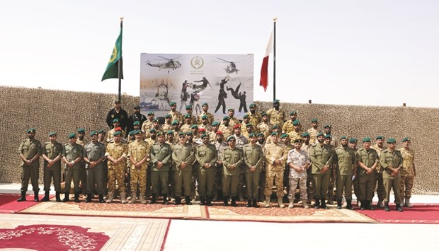 The new graduates of Emiri Guard School with Emiri Guard deputy commander and other officers of the school and the armed forces.