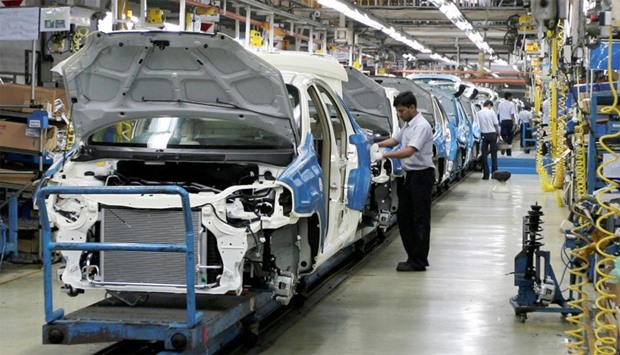 Employees work inside a plant of General Motors India Ltd. at Halol