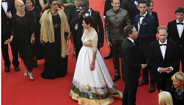 Israeli Culture Minister Miri Regev, wearing a dress featuring the old city of Jerusalem, arrives for the screening of the film 'Ismael's Ghosts' during the opening ceremony of the 70th edition of the Cannes Film Festival in Cannes, France.