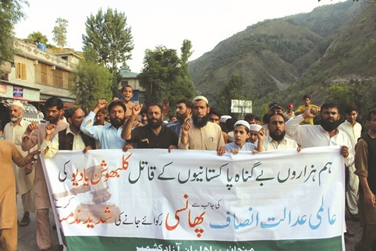 Pakistani Kashmiris hold a banner as they shout slogans during a protest against the UN in Muzaffarabad yesterday. The UNu2019s top court in The Hague yesterday ordered Pakistan to stay the execution of an Indian national convicted of spying.