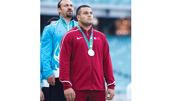 Qataru2019s Ashraf Amgad Elseify with his bronze medal on the podium for the menu2019s hammer throw competition at the Baku Olympic Stadium yesterday.