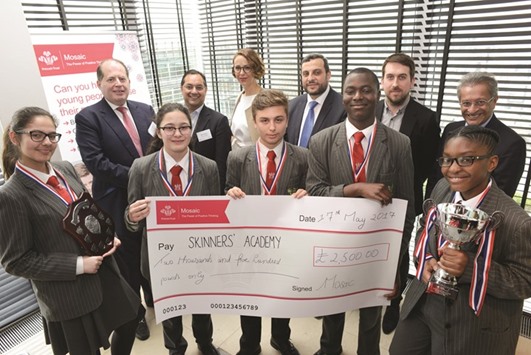 The winning team from Skinneru2019s Academy, London Region with the judging panel, including Fadi Itani (third right, second row).