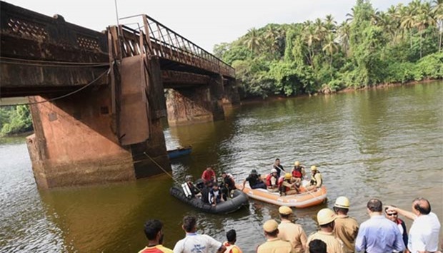Indian rescue workers and navy divers look for survivors near the footbridge collapse site in Curchorem, South Goa on Friday.