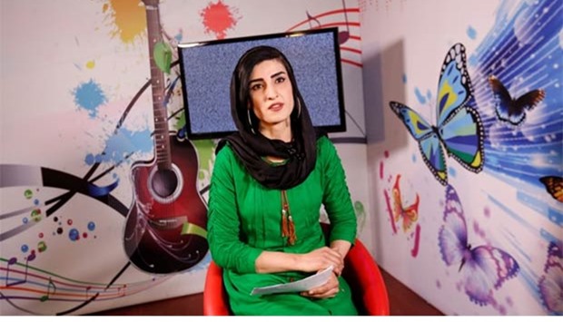 Krishma Naz, 22, presenter of a music show, sits during recording at the Zan TV station in Kabul.