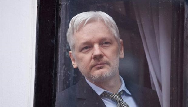 WikiLeaks founder Julian Assange looking out of a window at the Ecuadorean embassy in London in this file picture.