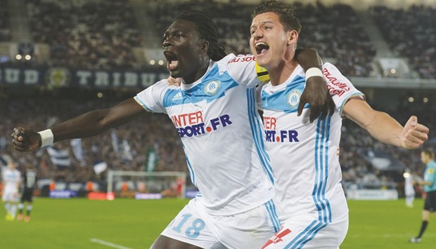 Marseilleu2019s French forward Bafetimbi Gomis (left) celebrates after scoring a goal with teammate Florian Thauvin during the French L1 match against Bordeaux in Bordeaux on Sunday. (AFP)