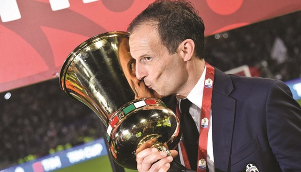 Juventusu2019 coach Massimiliano Allegri kisses the trophy after winning the Italian Tim Cup final at the Olympic stadium in Rome on Wednesday. (AFP)