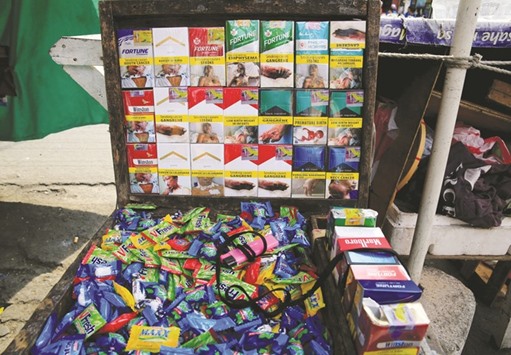 Different brands of cigarette packs are seen at a stall along a main street in Metro Manila.