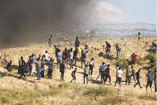 Palestinjavascript:__doPostBack('ctl00$MainContent$LinkButton1','')ian protesters hurl stones at Israeli troops following a protest against the blockade on Gaza, near the border between Israel and Central Gaza Strip yesterday.
