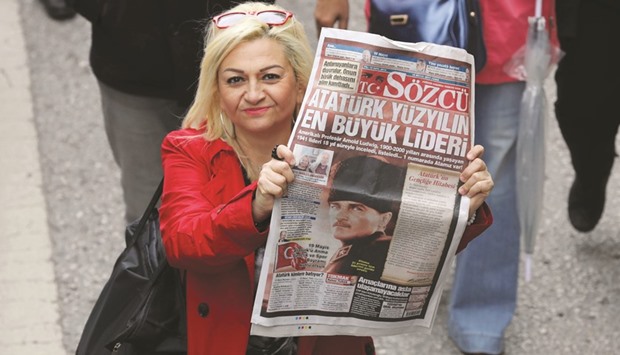 A woman holds up a copy of Sozcu after the ultra-secularist daily came under investigation by Istanbul prosecutors, during a march to Anitkabir, the mausoleum of modern Turkeyu2019s founder Mustafa Kemal Ataturk, during the u2018Ataturk, Youth and Sports Dayu2019 celebrations  yesterday in Ankara. May 19 marks the 98th anniversary of the beginning of the Turkish War of Independence on May 19, 1919.
