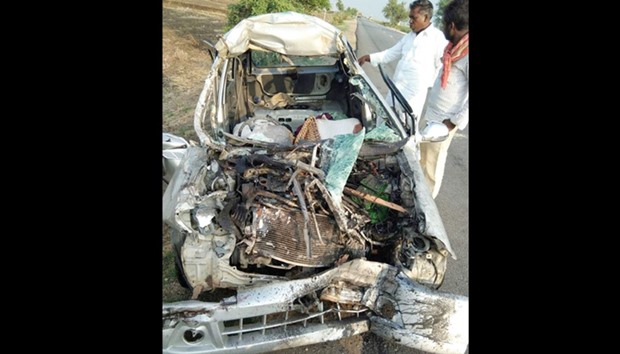 Two men look at the wreckage of a car that collided with a truck at Dadhesoguru near Sindhanur, in Raichur district of Karnataka yesterday. Five members of a family, including three children, were killed in the accident when the car collided head-on with the speeding truck.