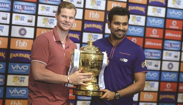 Rising Pune Supergiant captain Steven Smith (left) poses with Mumbai Indians captain Rohit Sharma and the winnersu2019 trophy on the eve of the Indian Premier League final in Hyderabad yesterday. (AFP)