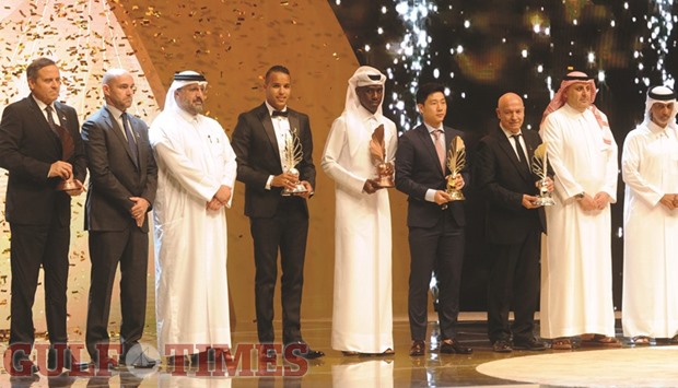 QFA president Sheikh Hamad bin Khalifa bin Ahmed al-Thani (right) with the winners of the QFA awards at the Qatar National Convention Centre yesterday. PICTURE: Shemeer Rasheed
