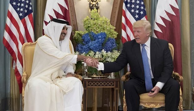 HH the Emir Sheikh Tamim bin Hamad al-Thani shakes hands with the US President Donald Trump in Riyadh on Sunday.