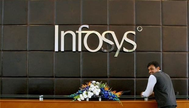 An Infosys employee stands at the front desk of its headquarters in Bengaluru.