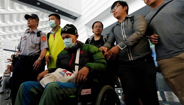 Taiwanese hiker Liang Sheng-yueh arrives at Taoyuan International Airport on Tuesday.