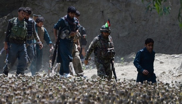 Afghan security force personnel patrol  the area