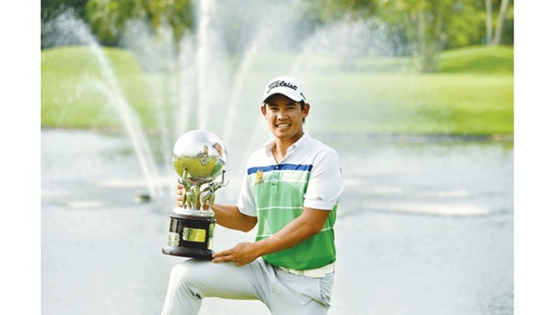 Thailandu2019s Rattanon Wannasrichan poses with the trophy after winning the Thailand Open in Bangkok. (AFP)