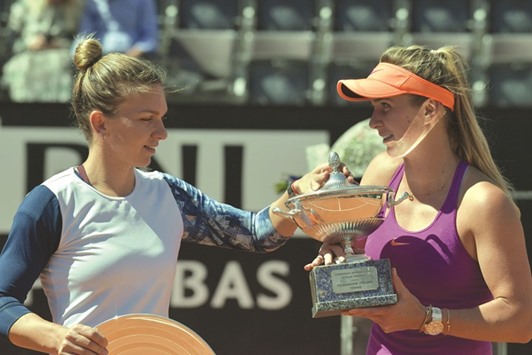 Elina Svitolina (R) of Ukraine poses with the trophy after defeating Simona Halep (L) of Romania at the Foro Italico in Rome.