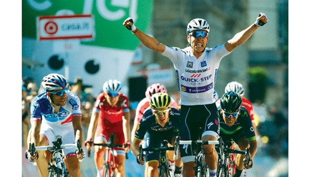 Luxemburgu2019s Bob Jungels celebrates as he crosses the finish line.