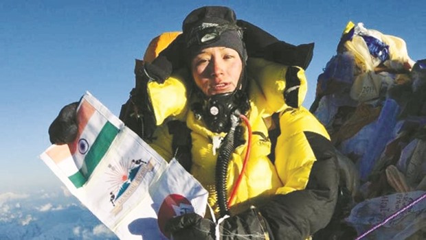 Anshu Jamsenpa unfurls the Indian flag after her record-breaking climb to Mt Everest.