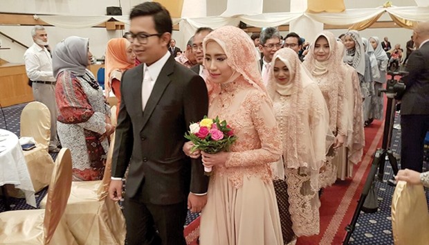 The celebration was preceded by a procession of the marriage ceremony, wedding tausiyah, reciting Islamic prayer, and giving congratulations to the bride and groom as well as both of their families.