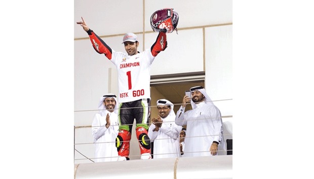 Saeed al-Sulaiti (second from left) celebrates after winning the Qatar Superstock 600 title on Saturday.