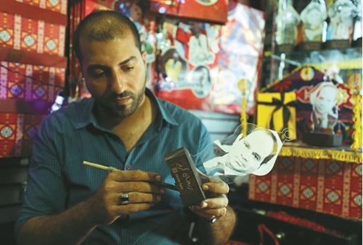 Mohamed Gamal works on a lantern with a portrait of Egyptu2019s President Abdel Fattah al-Sisi in Cairo.