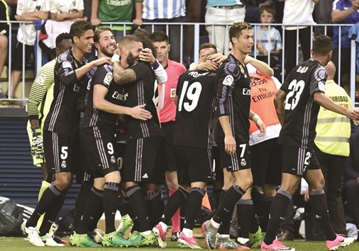 Real Madrid players celebrate after Karim Benzema scored a goal during their win over Malaga at La Rosaleda stadium in Malaga. (AFP)