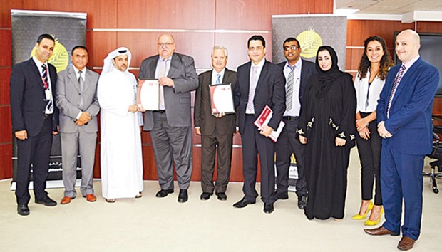 Al Meera officials receiving the ISO 9001:2015 certificate from Bureau Veritas.