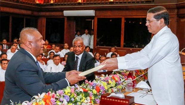 Mangala Samaraweera, who has been foreign minister since January 2015, takes oath as finance and media minister in front of Sri Lanka's President Maithripala Sirisena in Colombo on Monday.