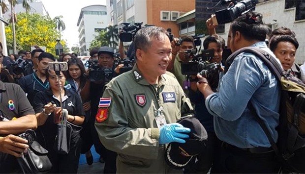 A Thai police commander of the explosive ordnance team, Kamthorn Aucharoen, leaves the Phramongkutklao Hospital after a bomb blast in Bangkok on Monday.
