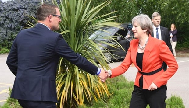 Prime Minister Theresa May is greeted by Conservative candidate for Wrexham Andrew Atkinson as she arrives at Gresford Memorial Hall in Gresford, North Wales, on Monday to launch the Welsh Conservative general election manifesto.