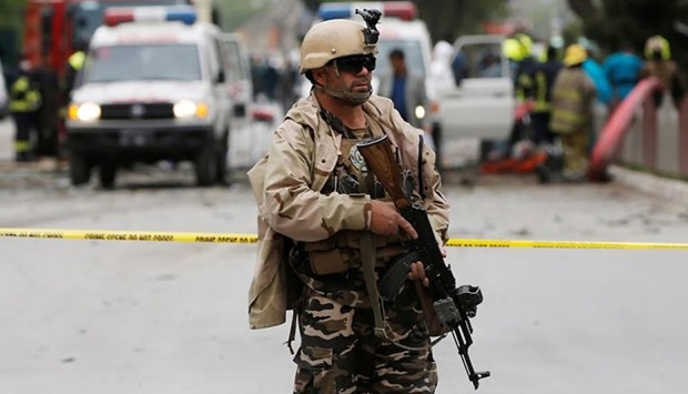 A member of the Afghan security force keeps watch at the site  in Kabul