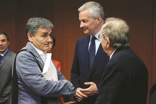From left: Greek Finance Minister Euclid Tsakalotos, French Economy Minister Bruno Le Maire and Italyu2019s Finance Minister Pier Carlo Padoan attend a eurozone finance ministers meeting in Brussels yesterday. Greece needs new cash from the eurozone to avoid a default in July when it has to repay some u20ac7.3bn worth of maturing loans.