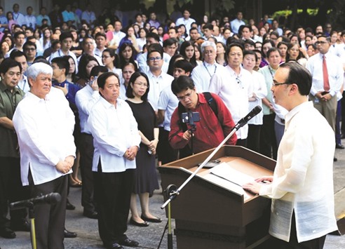 Newly-installed Foreign Secretary Alan Peter Cayetano (right) delivers a statement during a flag raising at the Department of Foreign Affairs headquarters in Pasay City, Metro Manila, yesterday.
