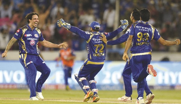 Mumbai Indiansu2019 Parthiv Patel (C) and Mitchell Johnson (L) celebrate with teammates after their IPL victory against Rising Pune Supergiant in Hyderabad on Sunday. (AFP)