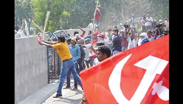Leftist activists try to breach a police barrier during a march towards the state secretariat in Kolkata yesterday. Demonstrators and police clashed in Kolkata during a march held by protesters to call for pricing reforms in the agriculture sector and greater food security.