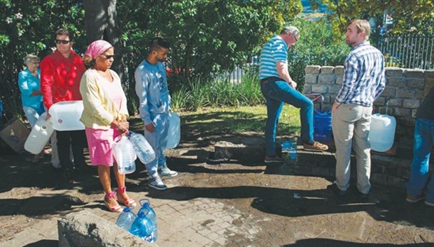 People queue up to collect drinking water from taps that are fed by a spring in Newlands, in Cape Town. South Africau2019s Western Cape region which includes Cape Town has declared a drought disaster as the province battled its worst water shortages for 113 years.